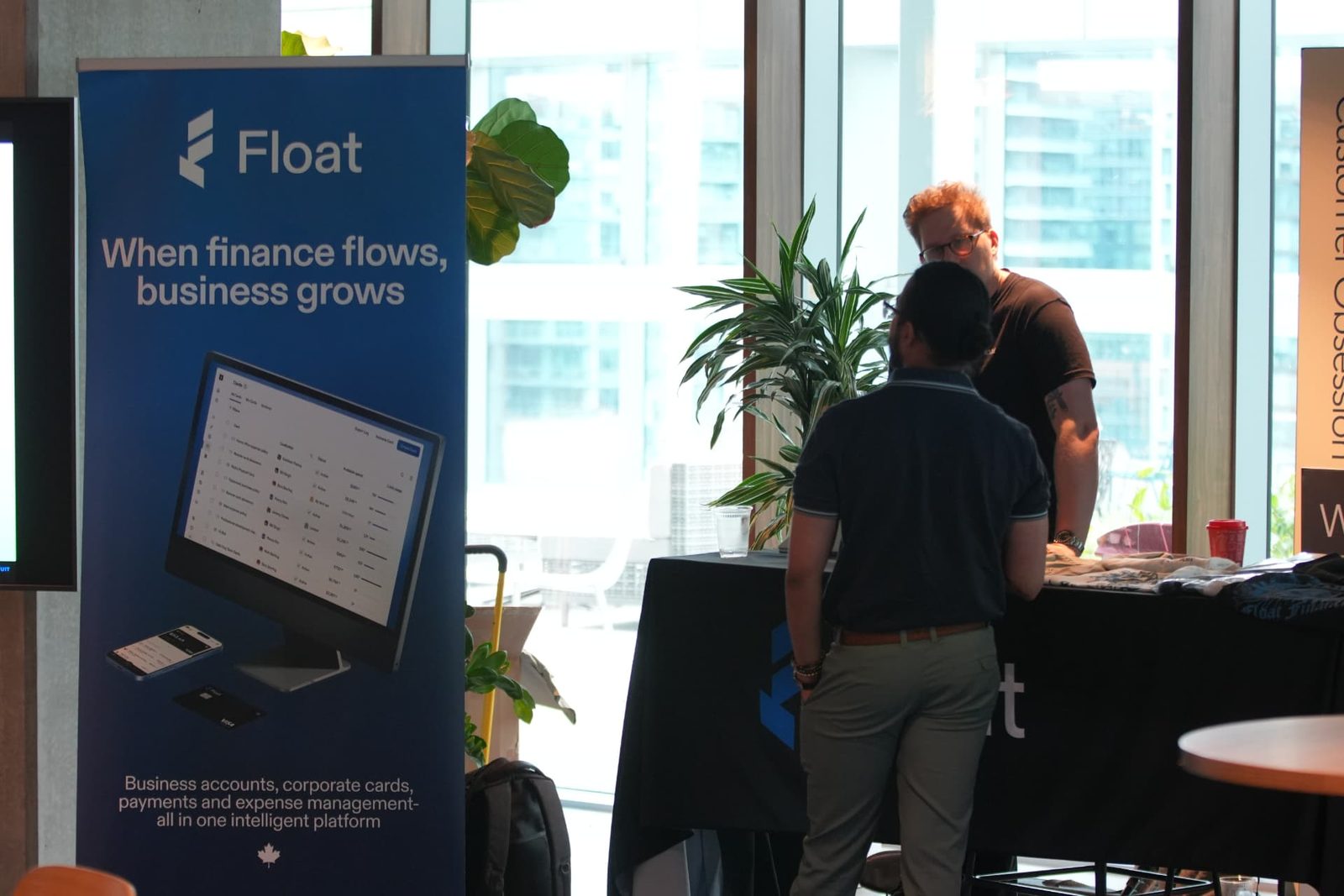 An attendee visiting the Float sponsor table