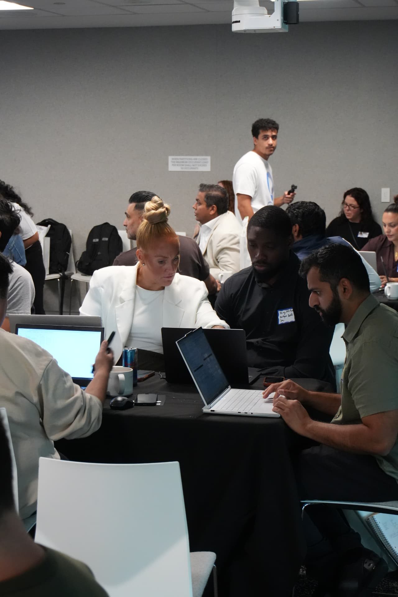 Attendees working together around a table during the workshop