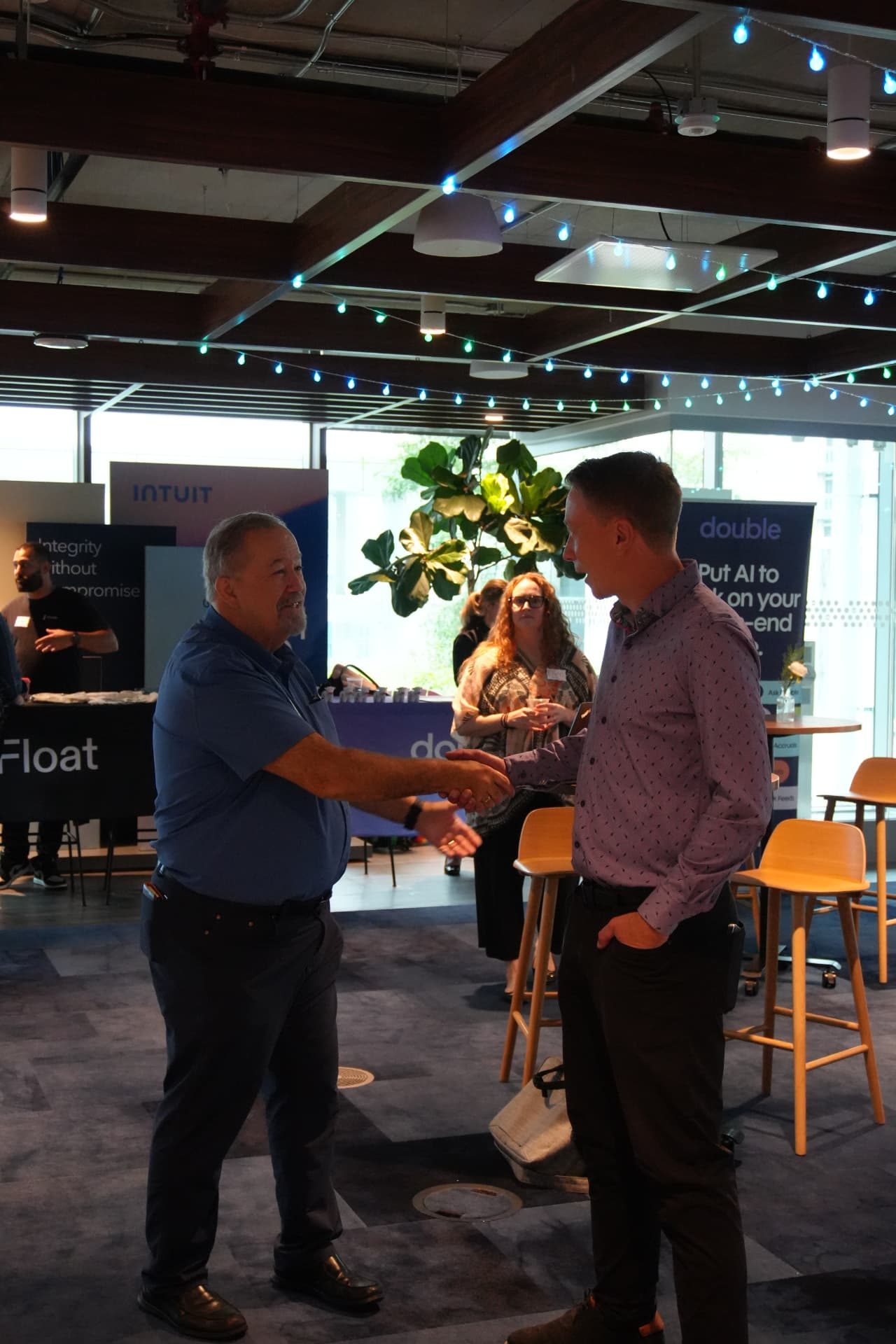 Two attendees greeting each other at the Toronto workshop