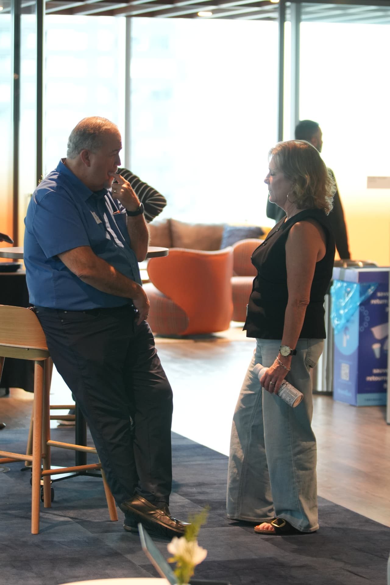 Two attendees talking between workshop sessions